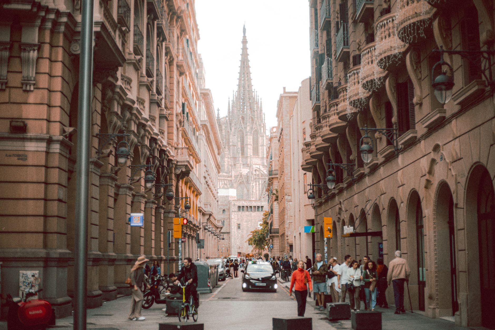 Panoramic view of Barcelona's historic Gothic Quarter at dawn, with narrow cobblestone streets and ancient buildings bathed in warm light.