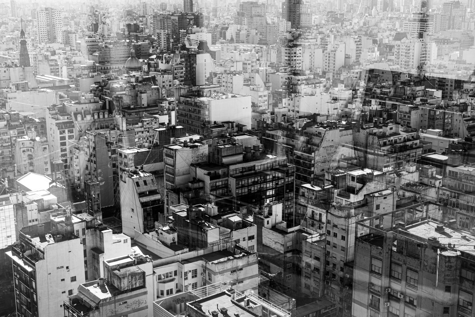 A sweeping view of Buenos Aires' diverse architecture, blending historic European styles with modern buildings under a clear sky.