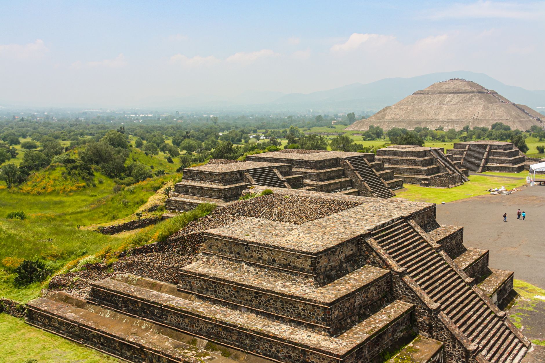 An aerial view of an ancient, sprawling city carved into a mountainside, suggesting hidden histories and vast landscapes awaiting discovery.
