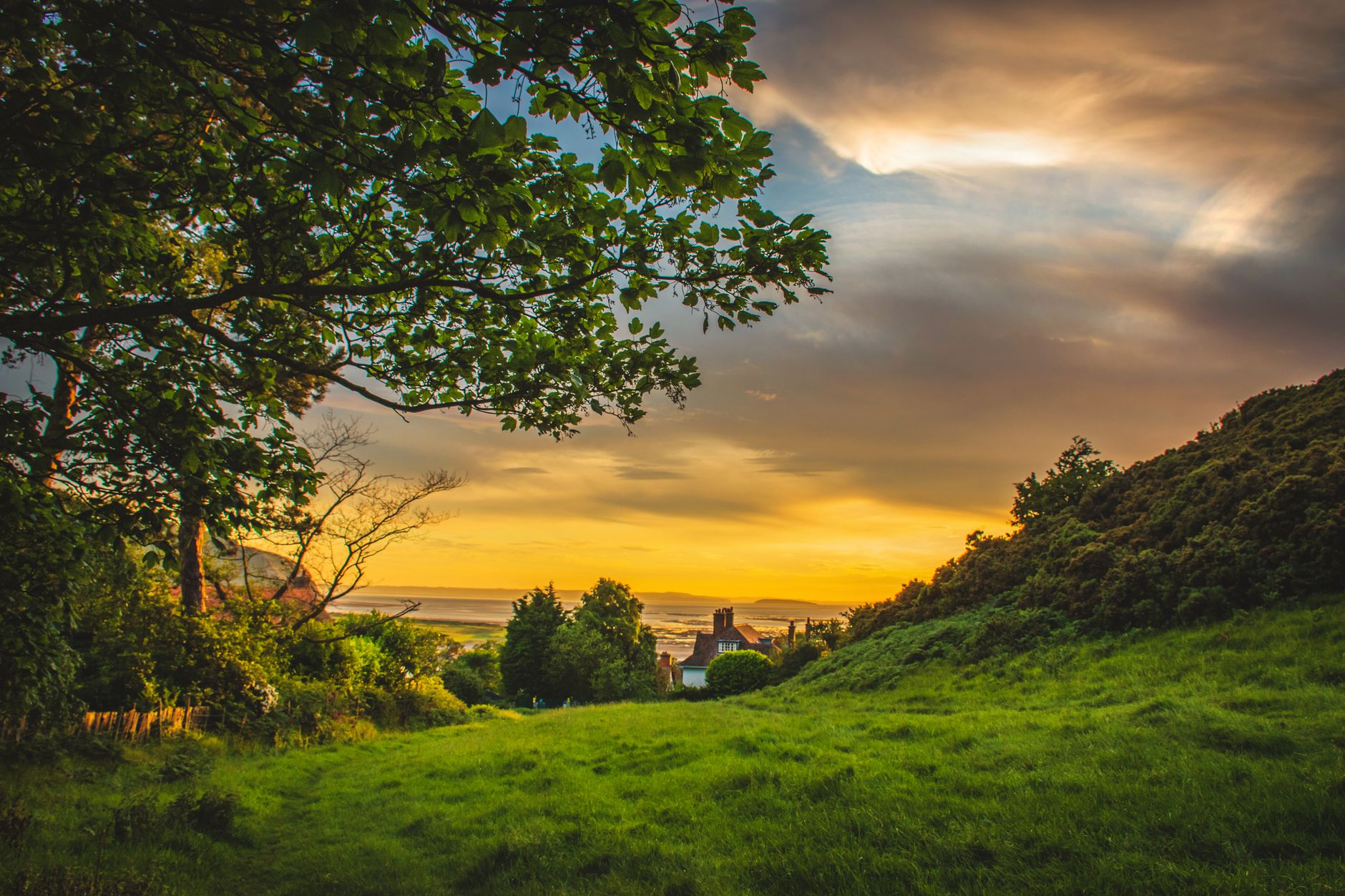 Sweeping vista showing diverse British landscapes, from rolling green hills to rugged coastlines and ancient stone structures, hinting at varied regional identities.