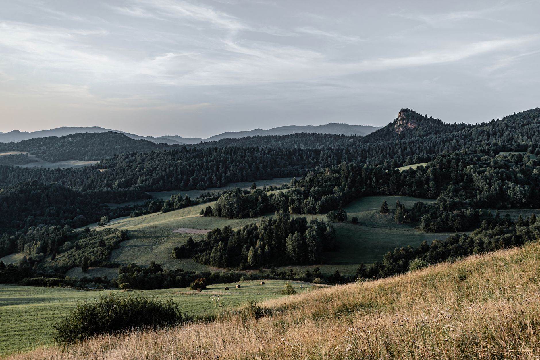 A vast, dramatic landscape featuring unusual geological formations under a wide sky, evoking a sense of ancient mystery and uncharted discovery.