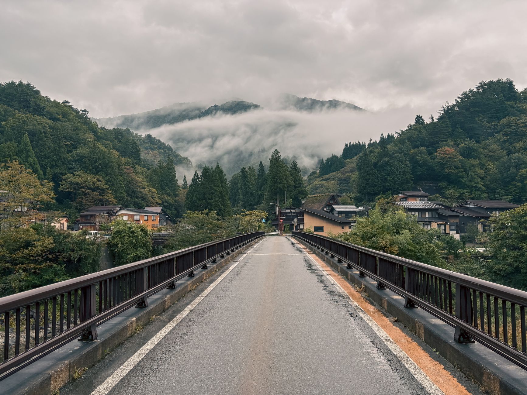 A winding path through a misty, ancient forest in rural Japan, hinting at undiscovered history and natural beauty.