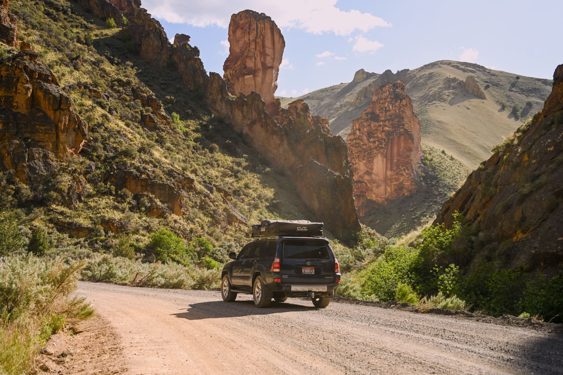 A lone traveler stands on a vast, open road stretching into a sunset, symbolizing the journey of self-discovery and changing perspectives through travel.