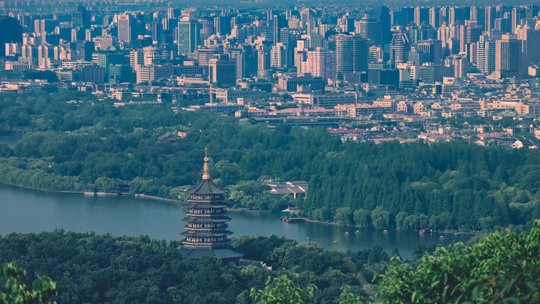 An aerial view of a bustling food festival in Hangzhou, with traditional Chinese architecture and people sampling street food.