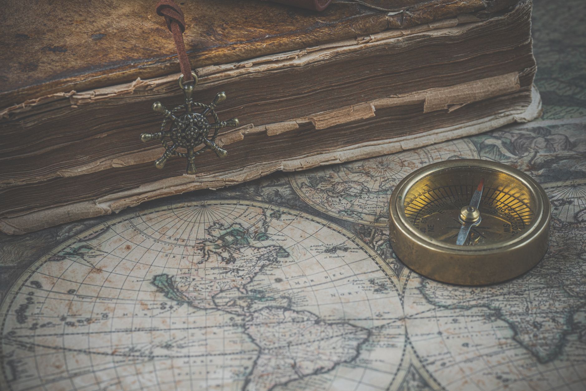 An ancient, weathered map unfurled on a rustic table, hinting at forgotten paths and hidden wonders.
