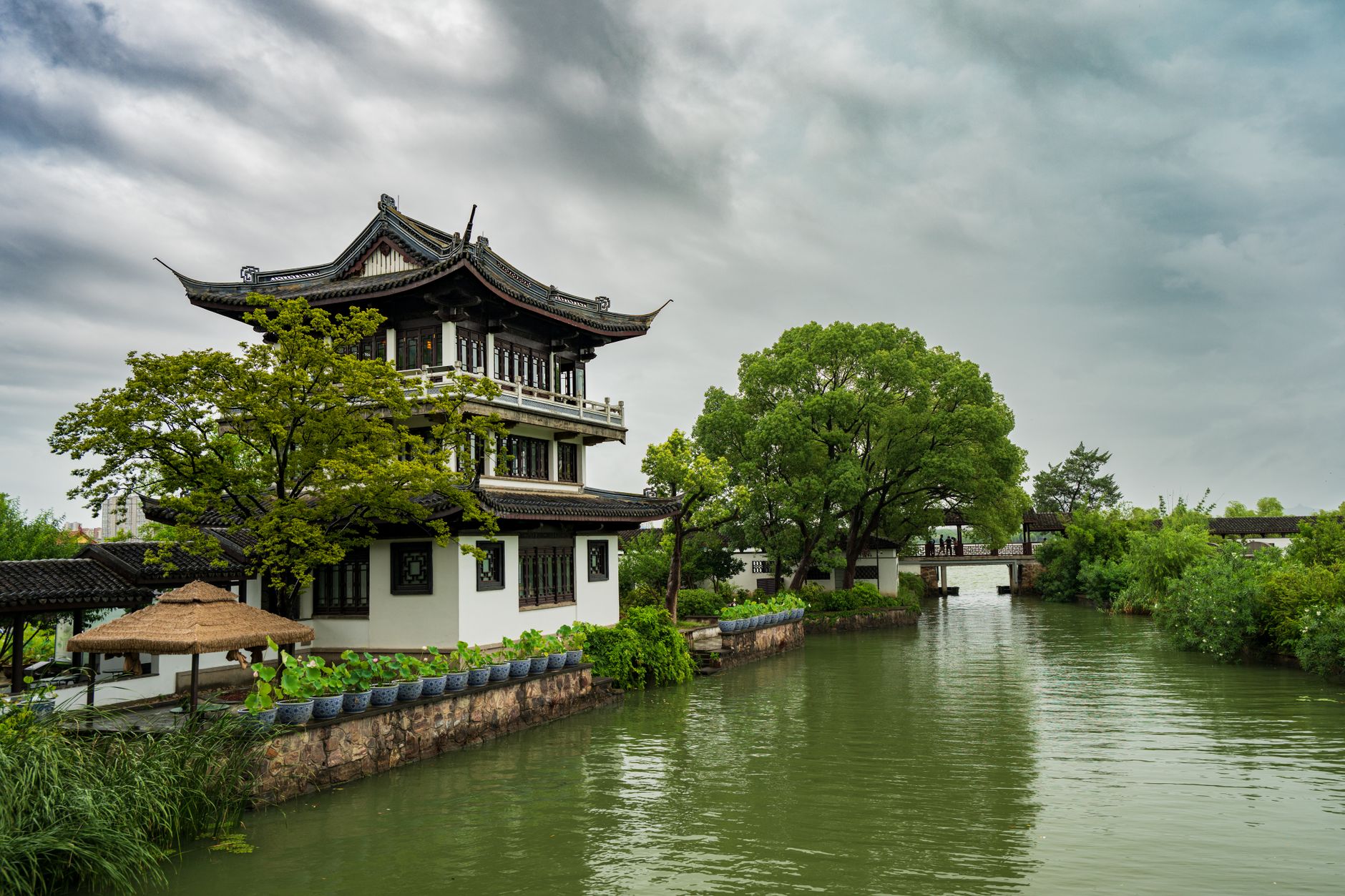 Sweeping view of ancient Chinese villages nestled in misty, dramatic mountains with traditional architecture.