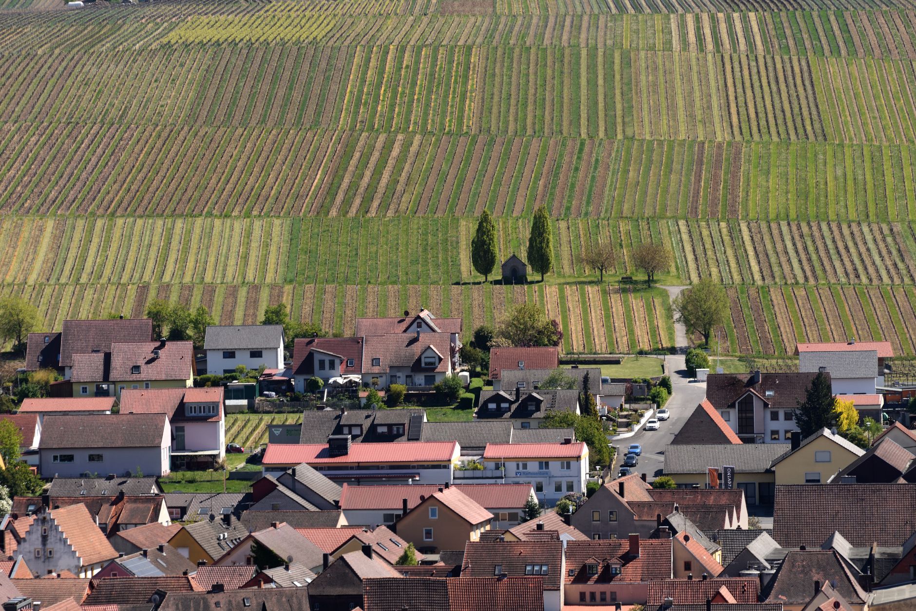 Panoramic view of a charming, historic European town nestled by a coastline, hinting at hidden travel gems.