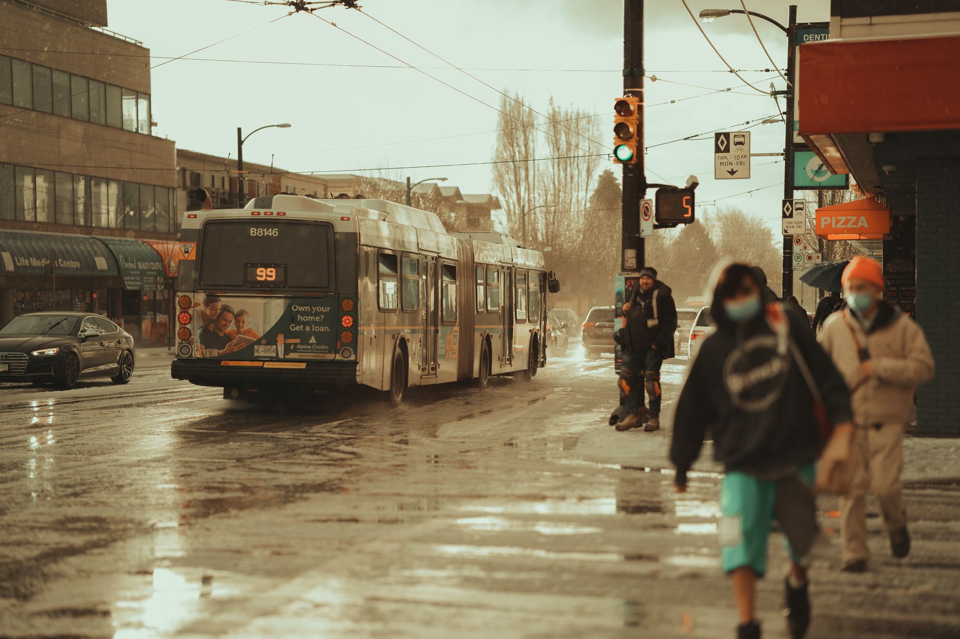 Rainy Canadian cityscape with modern skyscrapers in Toronto, Montreal, and Calgary, evoking a clean, vibrant urban environment.
