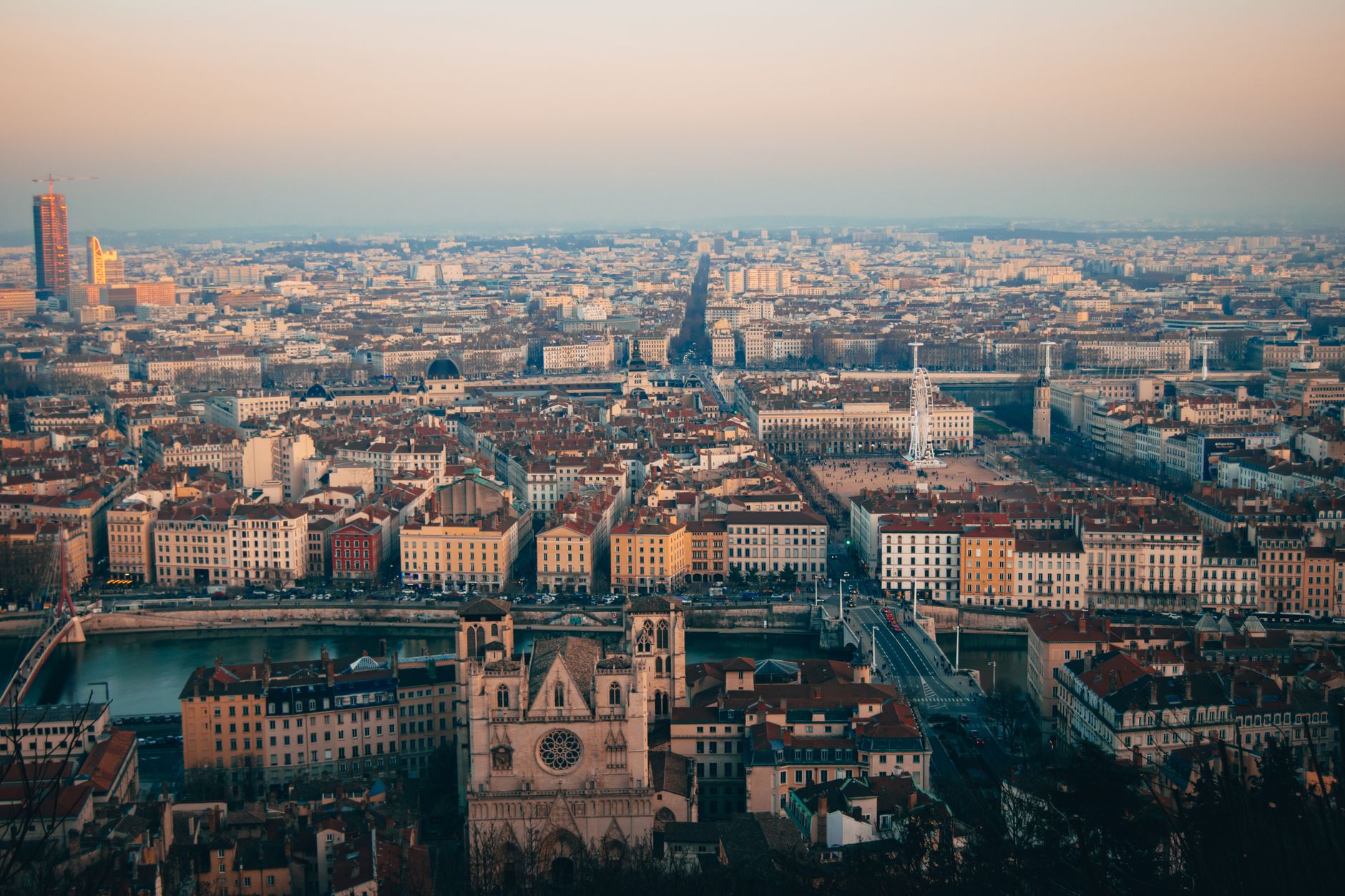 A panoramic view of Lyon's historic skyline, blending ancient Roman architecture with Renaissance buildings and the narrow alleys of the Croix-Rousse district.