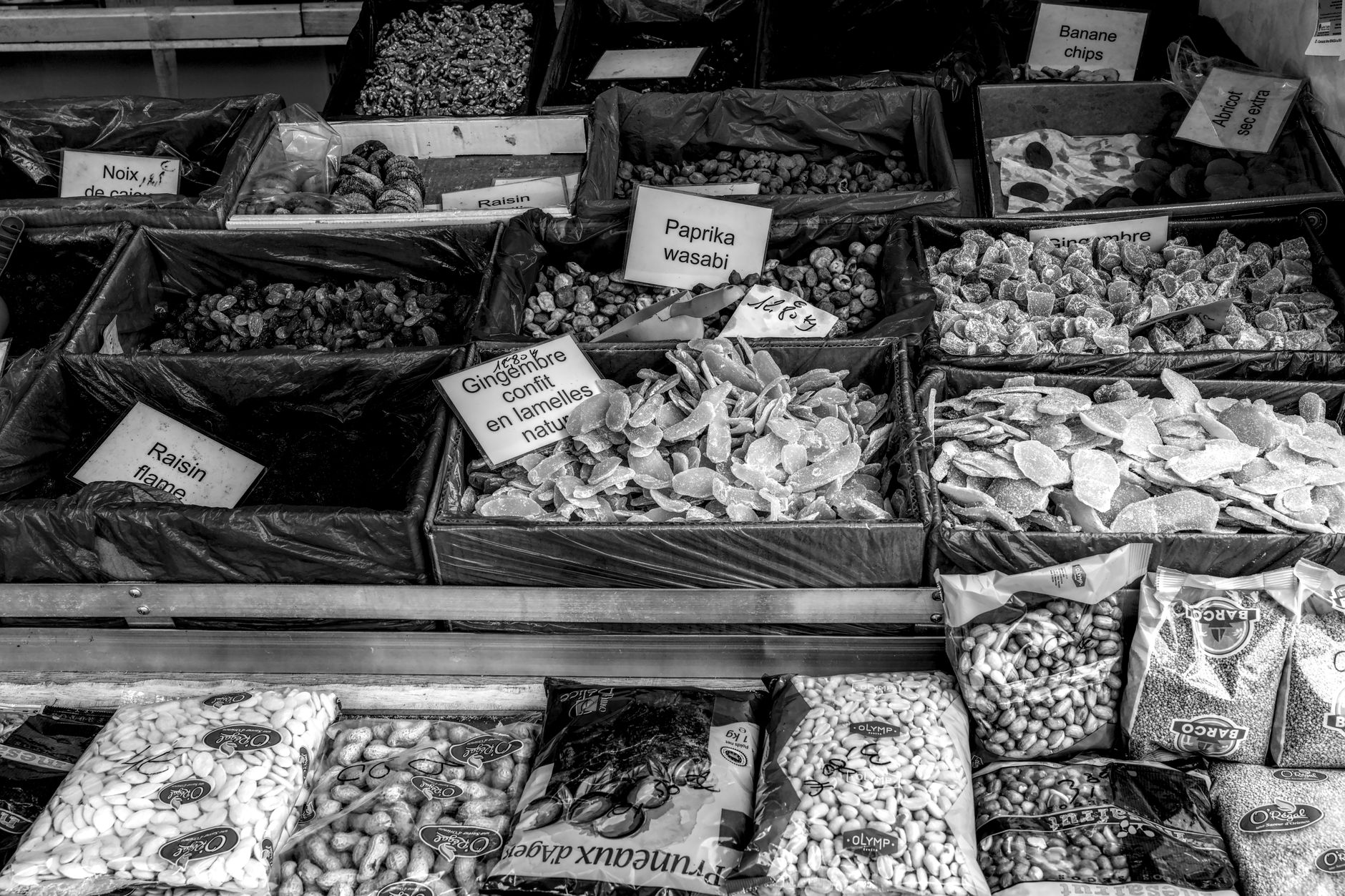 A vibrant outdoor market in a French village, showcasing fresh produce, local cheeses, and artisanal breads under a sunny sky.