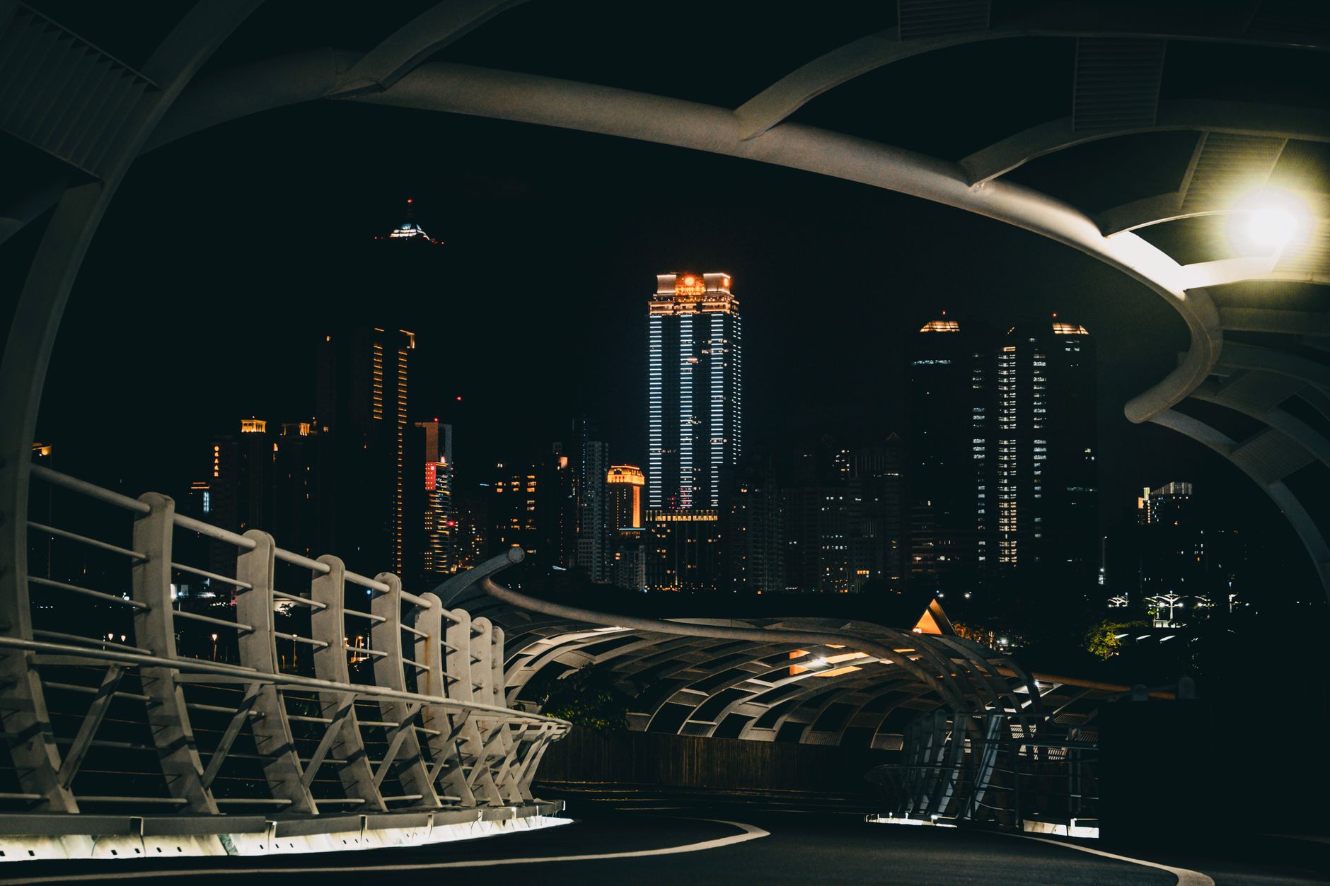 Panoramic view of Kaohsiung city at sunset, with the harbor and skyscrapers illuminated.