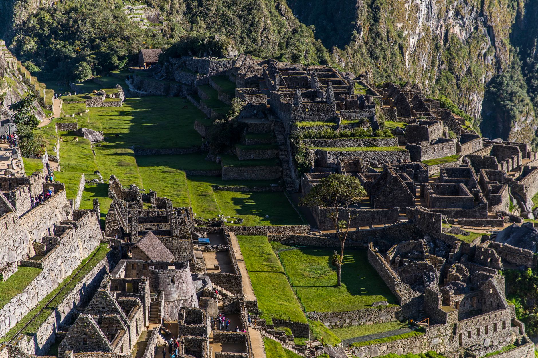 An aerial view of an ancient, partially excavated city nestled amongst rolling hills under a dramatic sky, evoking a sense of mystery and discovery.