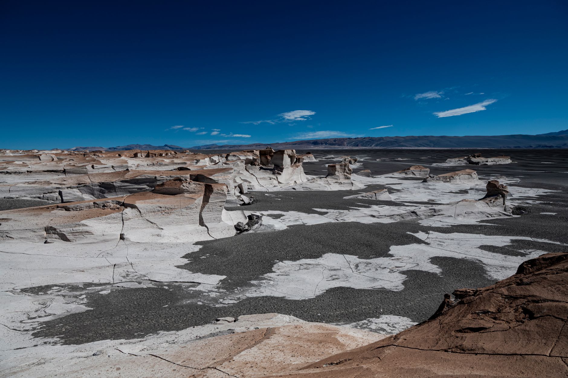 A sweeping panoramic view of a dramatic and unique landscape, hinting at diverse and surprising travel destinations around the world.