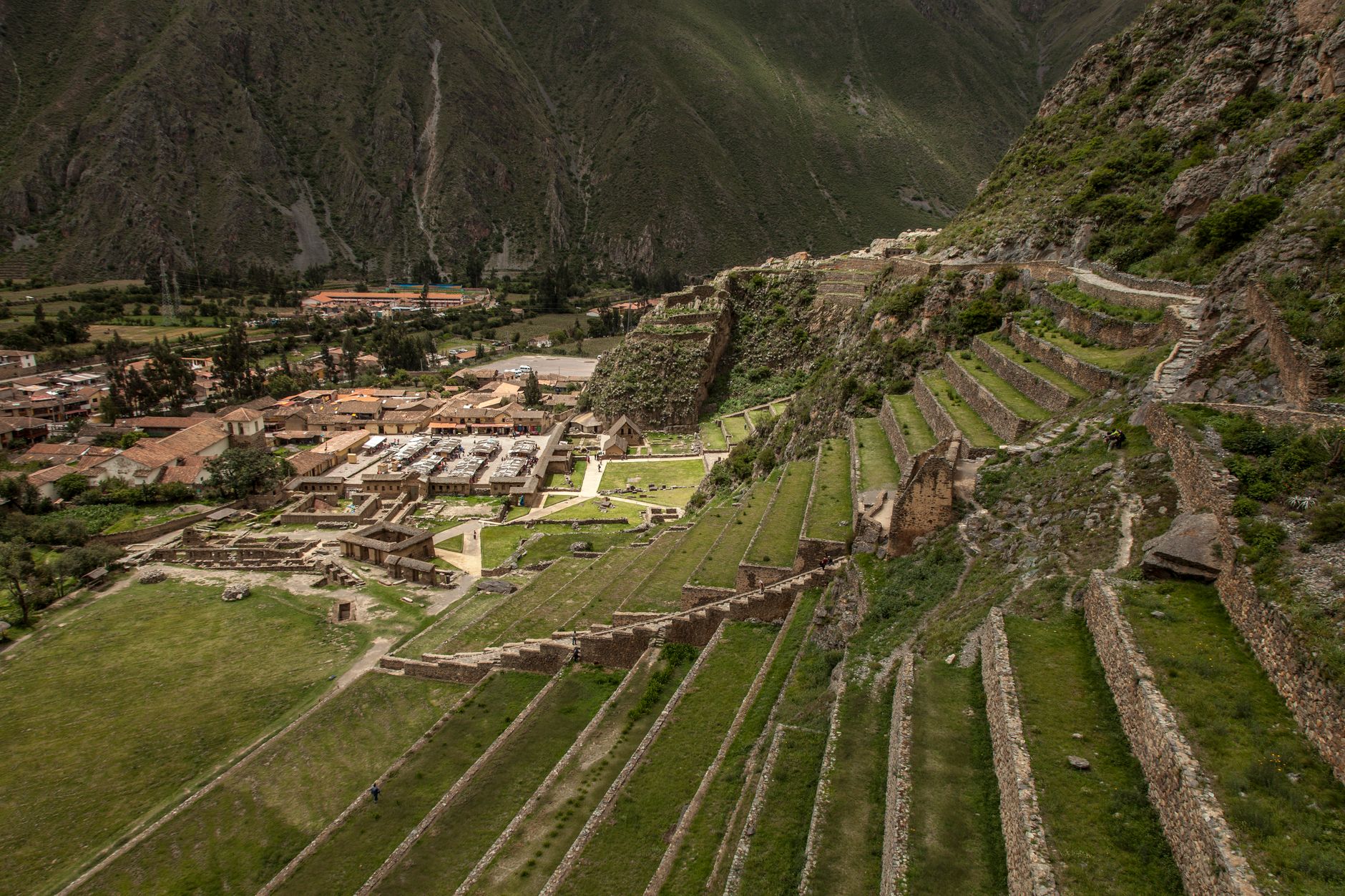 Sweeping view of ancient terraced fields in a lush valley, with a small village nestled among them, hinting at sustainable food practices.
