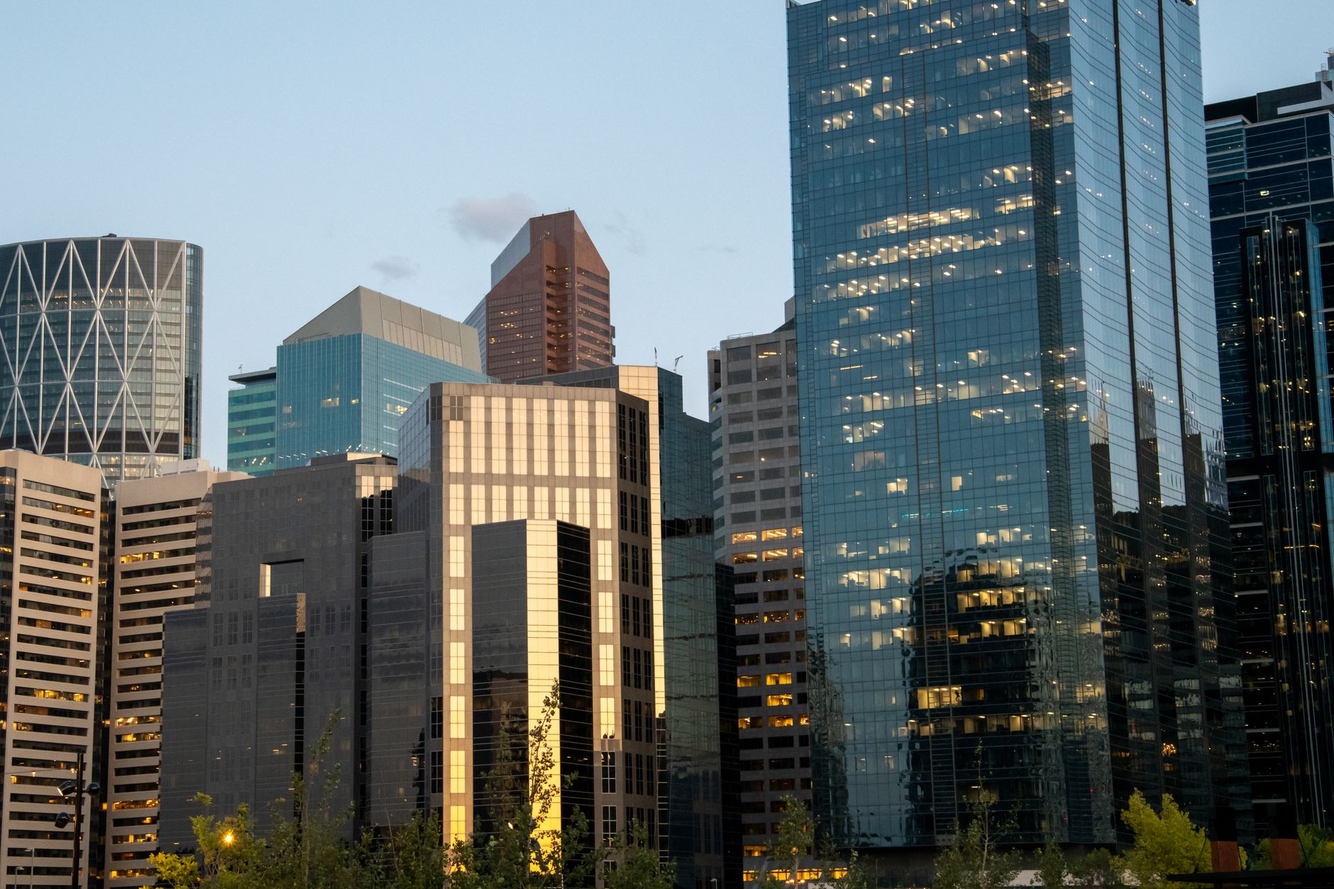A panoramic view showcasing the contrasting urban and natural landscapes of Calgary and Kitchener, hinting at hidden historical and geological treasures.