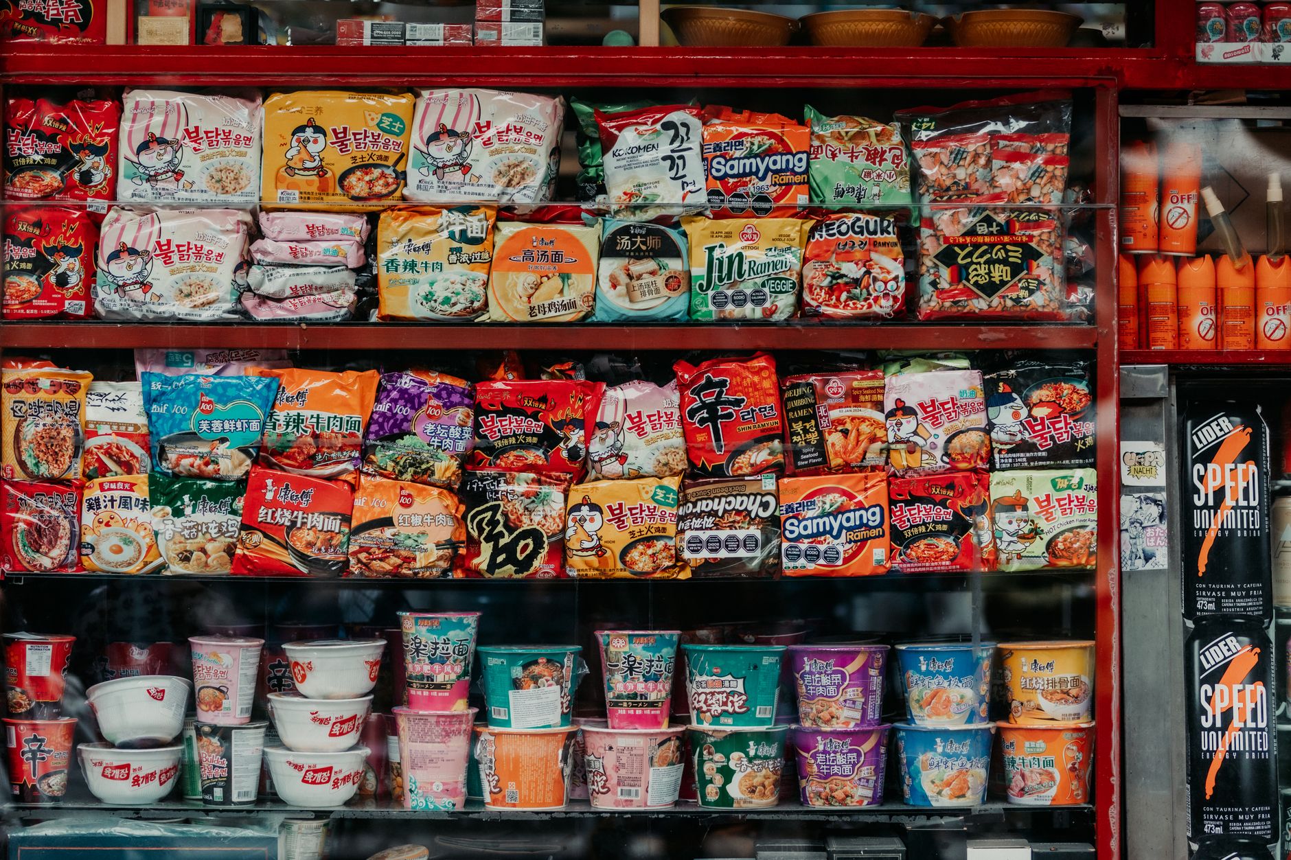 A vibrant, sweeping shot of a diverse food market with people bustling, showcasing various colorful ingredients and dishes from around the world.