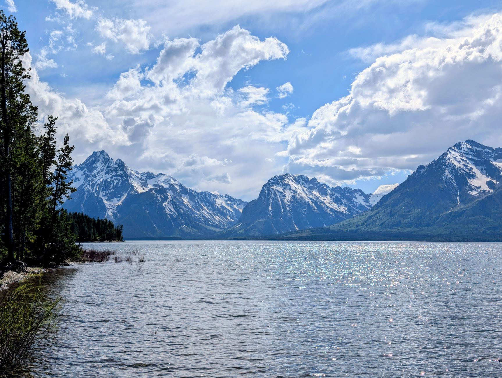 Sweeping vista of diverse North American landscapes, from mountains to coastlines, hinting at untold stories.