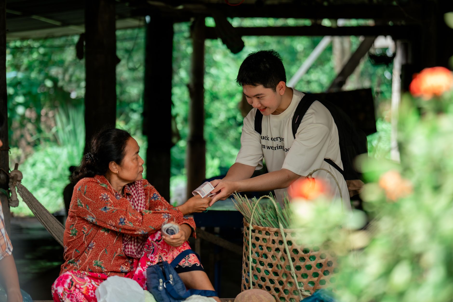A traveler shares a laugh with a local artisan in a bustling, non-touristy market, surrounded by colorful wares and engaged conversations, symbolizing authentic cultural exchange.
